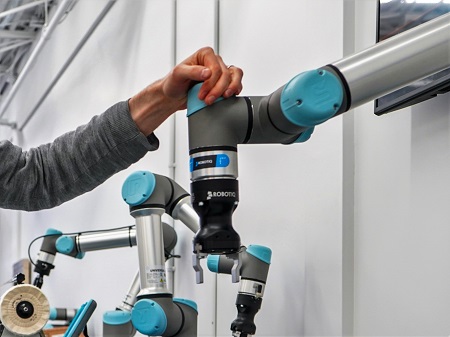 Image That Represents The Cobot Which Can Be Hold By A Woman Hand.