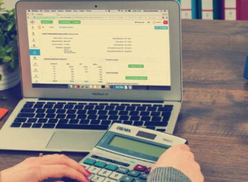 Man Calculating Bills For Salary At Office